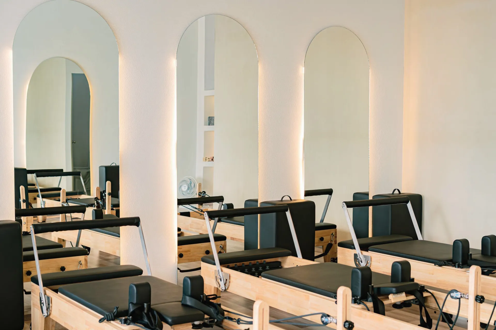Light-filled reformer studio with arched windows